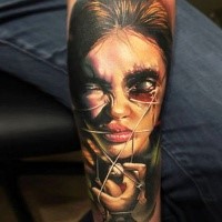 Colored horror style colored forearm tattoo of monster woman
