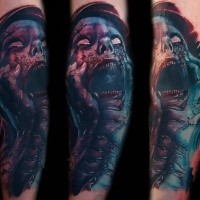 Colored horror style creepy looking arm tattoo of monster face