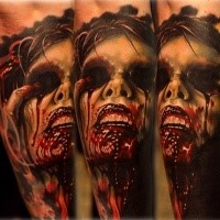 Colored horror style creepy looking arm tattoo of bloody woman