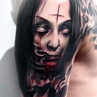 Colored horror style creepy looking bloody woman face tattoo on shoulder