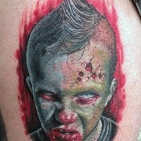 Colored horror style creepy looking bloody boy head tattoo on thigh