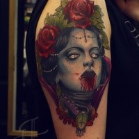 Colored horror style creepy looking bloody woman face tattoo on shoulder with roses