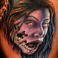 Colored horror style creepy looking demonic woman face tattoo