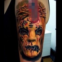 Colored horror style creepy looking face with vine tattoo on shoulder