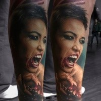 Colored horror style creepy looking leg tattoo of bloody woman face