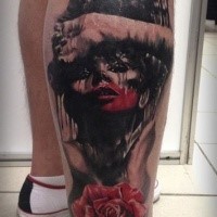 Colored horror style creepy looking leg tattoo of bloody woman with rose