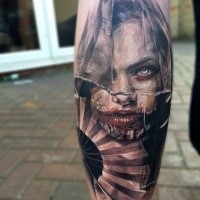 Colored horror style creepy looking leg tattoo of woman face