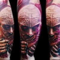 Colored horror style creepy looking leg tattoo od demonic face