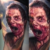 Colored horror style creepy looking man portrait tattoo on thigh