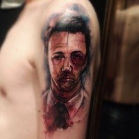 Colored horror style creepy looking man tattoo on shoulder