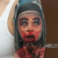 Colored horror style creepy looking shoulder tattoo of demonic woman