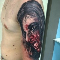Colored horror style creepy looking shoulder tattoo of bloody woman