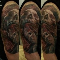 Colored horror style creepy looking shoulder tattoo of human skull with coffin and bloody hand