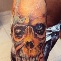 Colored horror style forearm tattoo of human skull