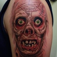 Colored horror style large shoulder tattoo of monster face