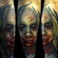 Colored horror style mystical looking arm tattoo of bloody girl