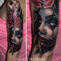 Colored horror style shoulder tattoo of woman portrait with flower
