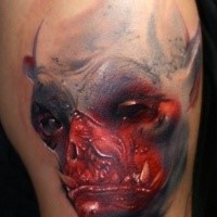 Colored horror style shoulder tattoo of bloody demon
