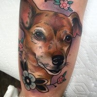 Colored illustrative style arm tattoo of cute dog with flowers