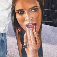 Colored illustrative style colored forearm tattoo of woman with lipstick