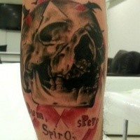 Colored illustrative style leg tattoo of human skull with lettering