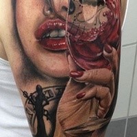 Colored illustrative style shoulder tattoo of woman portrait with glass of wine