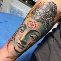 Colored impressive looking arm tattoo of Buddha statue with ornament