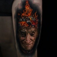 Colored incredible looking thigh tattoo of mn with burning head