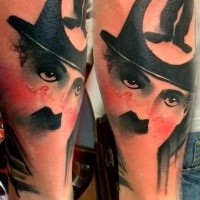 Colored interesting looking arm tattoo of Charlie Chaplin portrait