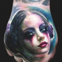 Colored interesting looking hand tattoo of funny girl