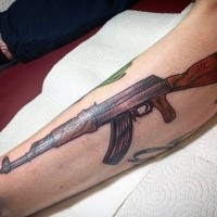 Colored leg tattoo of detailed AK rifle