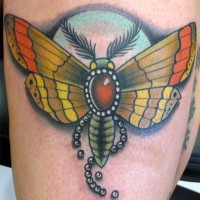 Colored moth tattoo on leg