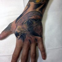 Colored natural looking small hand tattoo of eagle head