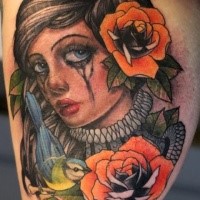 Colored new school colored crying woman portrait tattoo on biceps with flowers and bird
