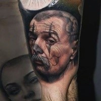 Colored realism style biceps tattoo of man face with mustache