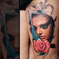 Colored thigh tattoo of woman with pink rose