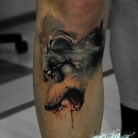 Colored very creepy looking leg tattoo of bloody wolf head