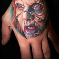 Colorful exorcist movie horror tattoo on hand