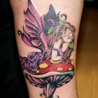 Colorful fairy lying on mushroom tattoo