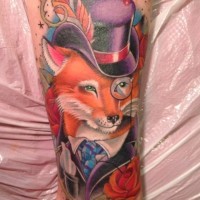 Colorful fox in a hat and prince tattoo on leg
