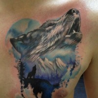 Colorful howling wolf and silhouette of a wolf in mountains tattoo on chest