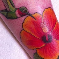 Colorful hummingbird and hibiscus tattoo