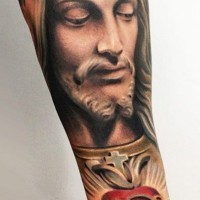 Colorful jesus and red heart forearm tattoo