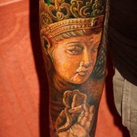 Colorful meditating buddha forearm tattoo