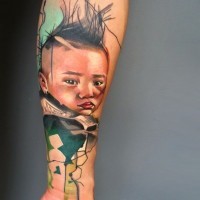Colorful portrait of a child forearm tattoo by Ivana Belakova