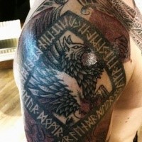 Colorful shoulder tattoo of ancient lettering with eagle