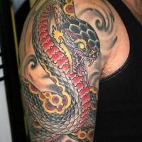 Colorful tattoo of a snake on shoulder
