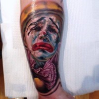 Colorful tearful clown tattoo by Fabian de Gaillande