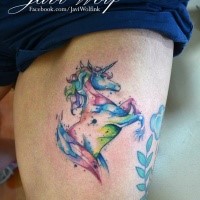 Colorful unicorn tattoo on thigh by Javi Wolf with paint drips in watercolor style