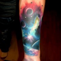 Colorful watercolor planets in space forearm tattoo